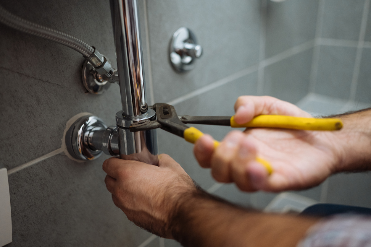 Plumber Repairing Bathroom Pipes