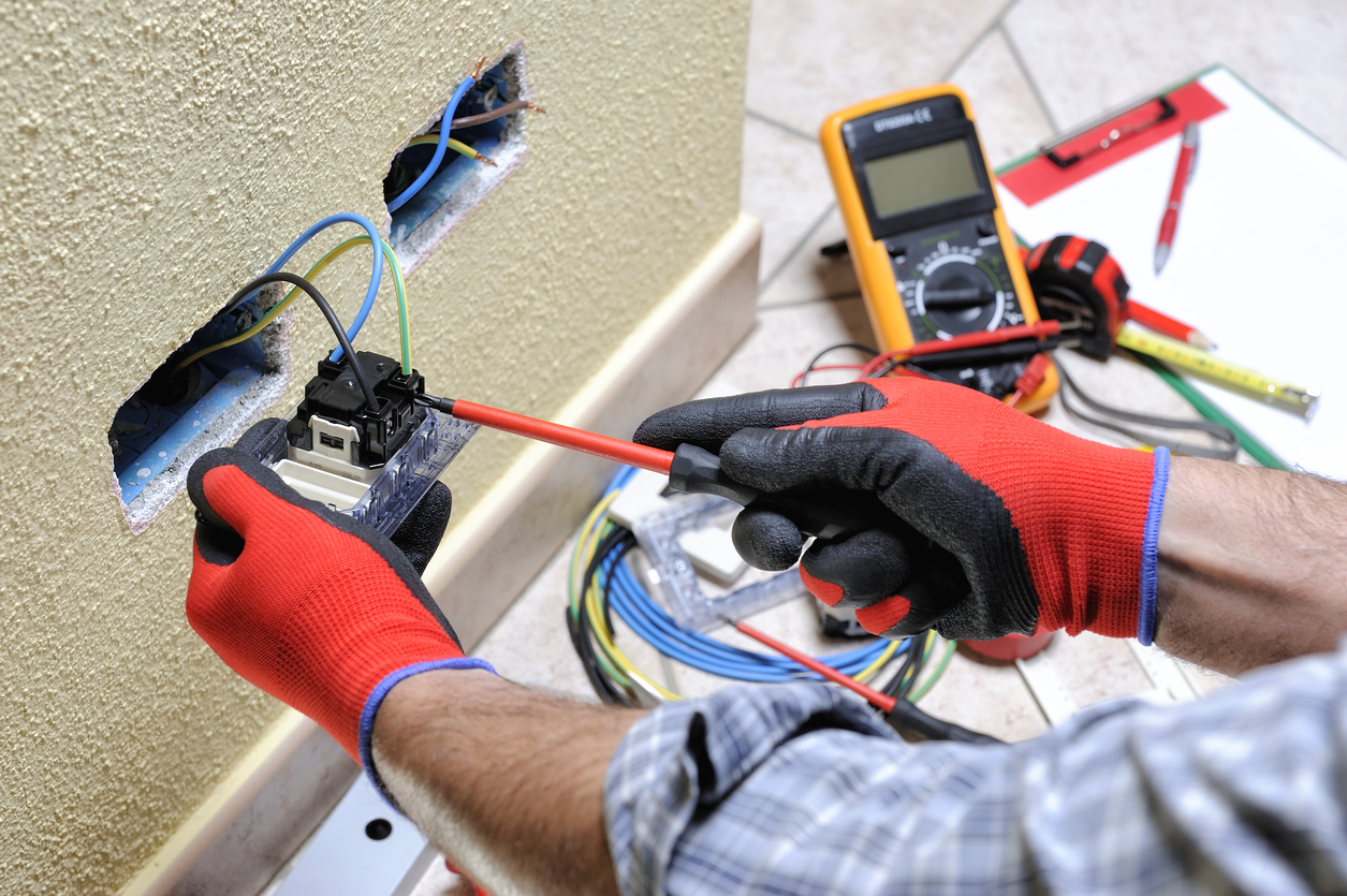 Expert Electrician Working On Outlet