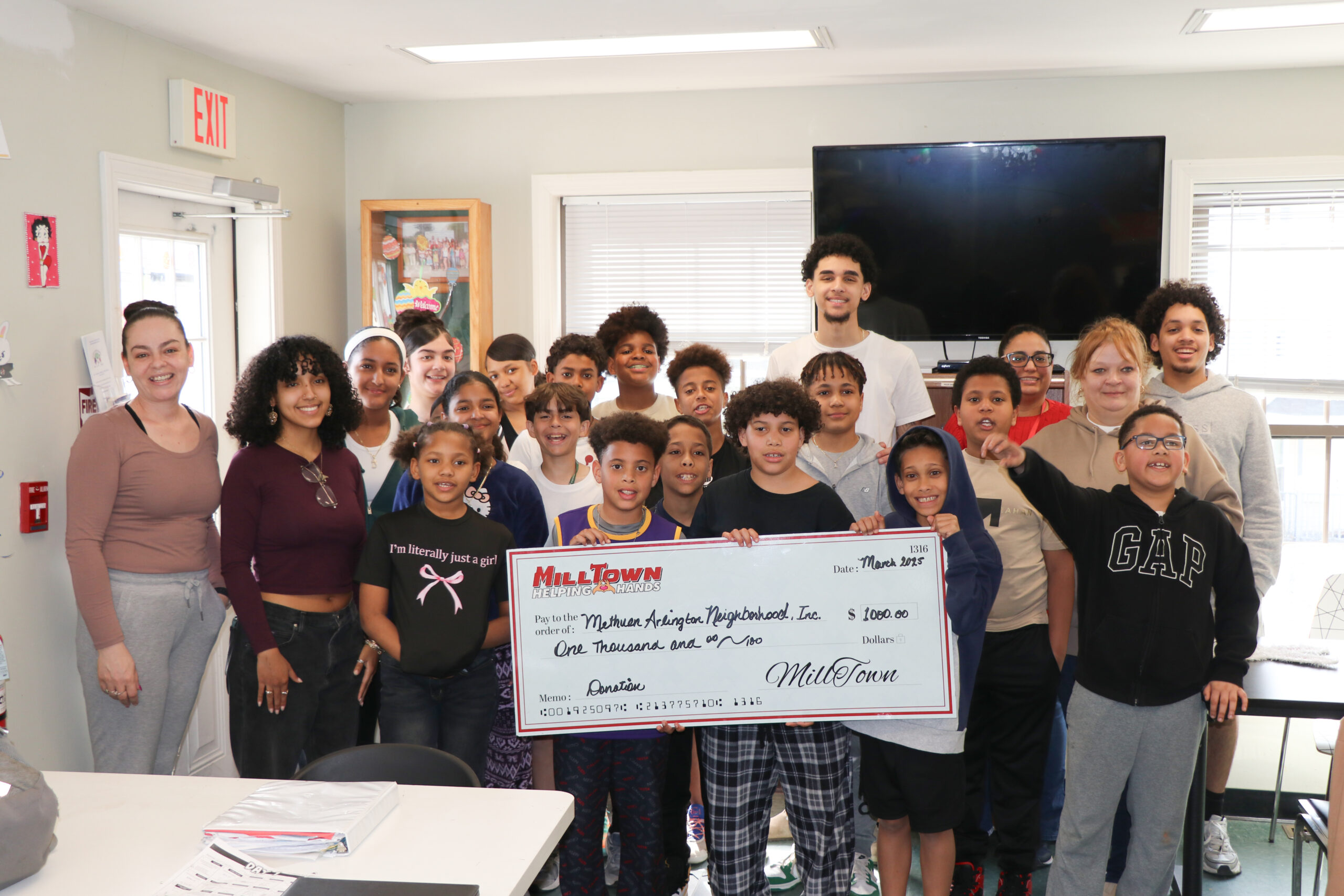 The people of MAN Inc. holding their Helping Hands donation from MillTown Plumbing, Heating, Cooling & Electrical