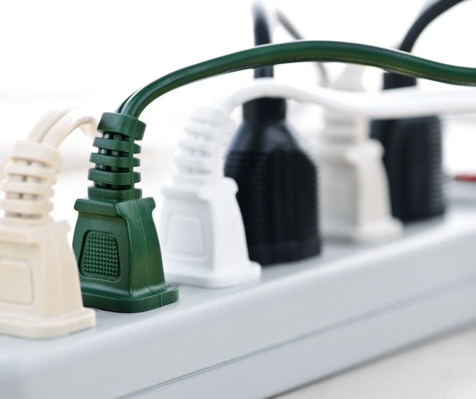 Many cords for electronics plugged in to a surge protector