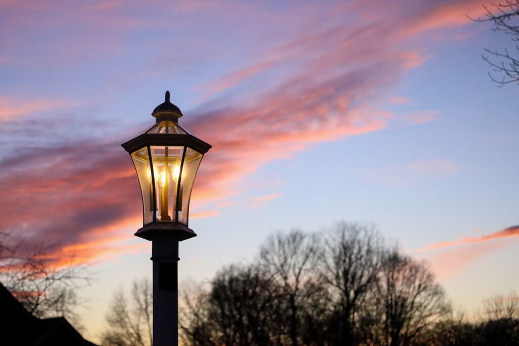 A streetlight illuminates a home at night