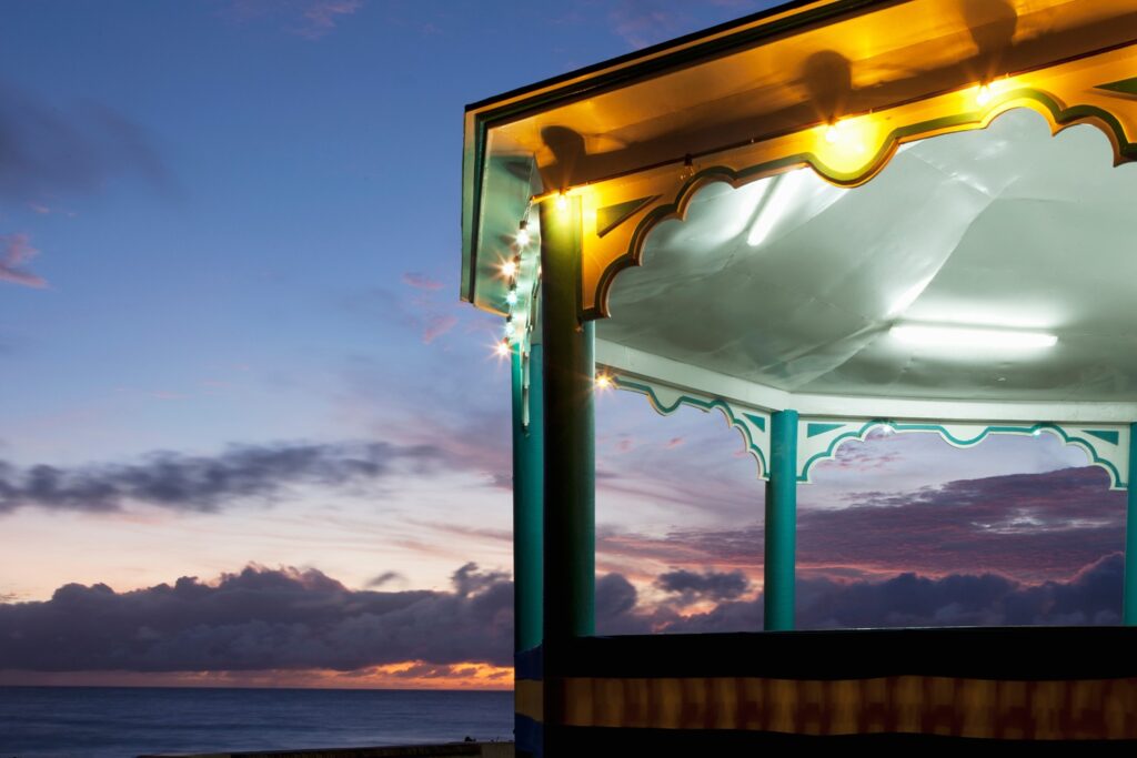 Sunset viewed from ornate gazebo with recessed lighting on ceiling