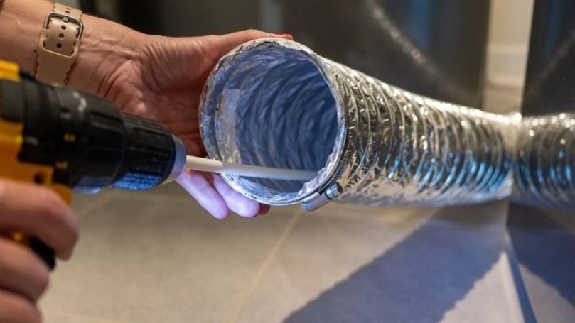 Dryer vent cleaning service performed by a technician